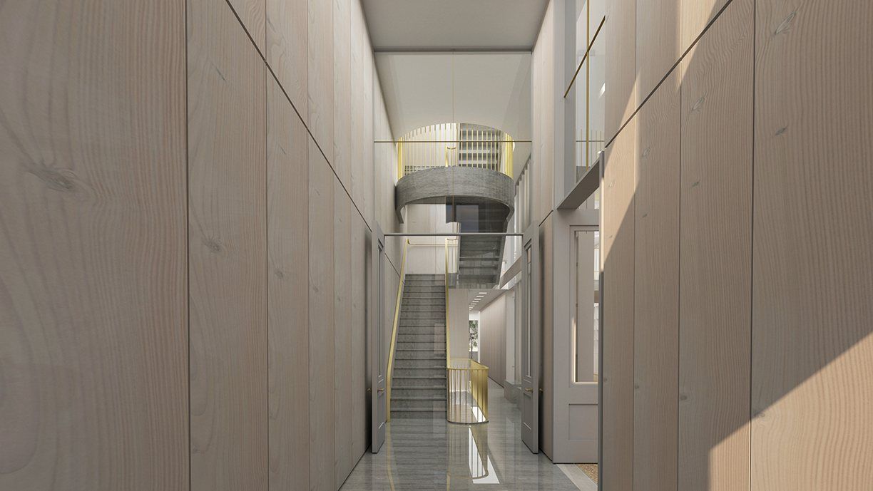 A narrow hall lined in pale timber, a stair rising towards light at the far end.