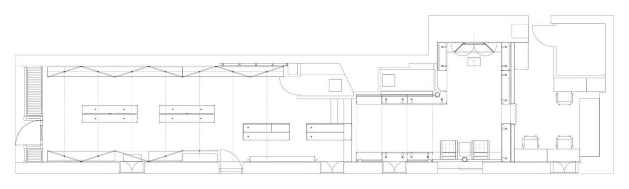 Line drawing of the long, narrow shop plan with tables and wall displays.