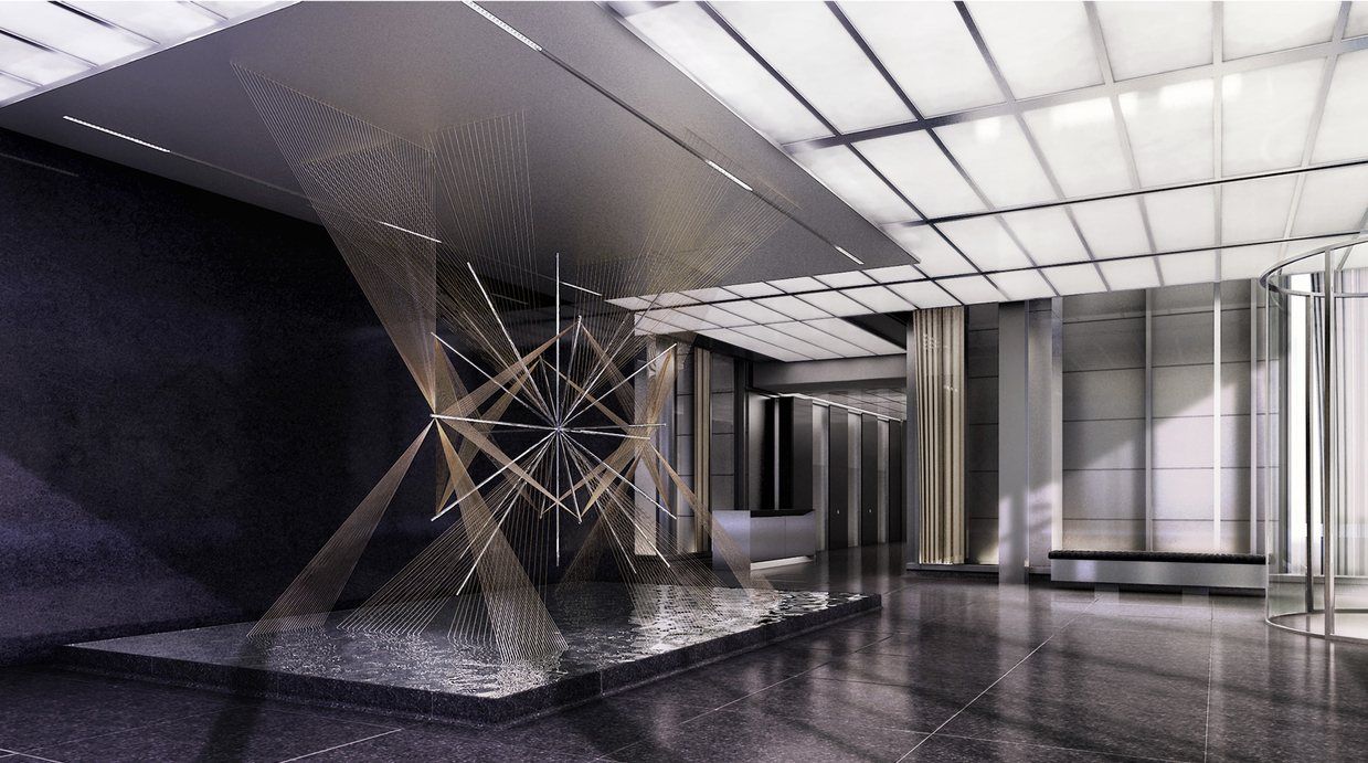 A dark stone lobby with a suspended sculpture of crossing lines over a shallow pool.