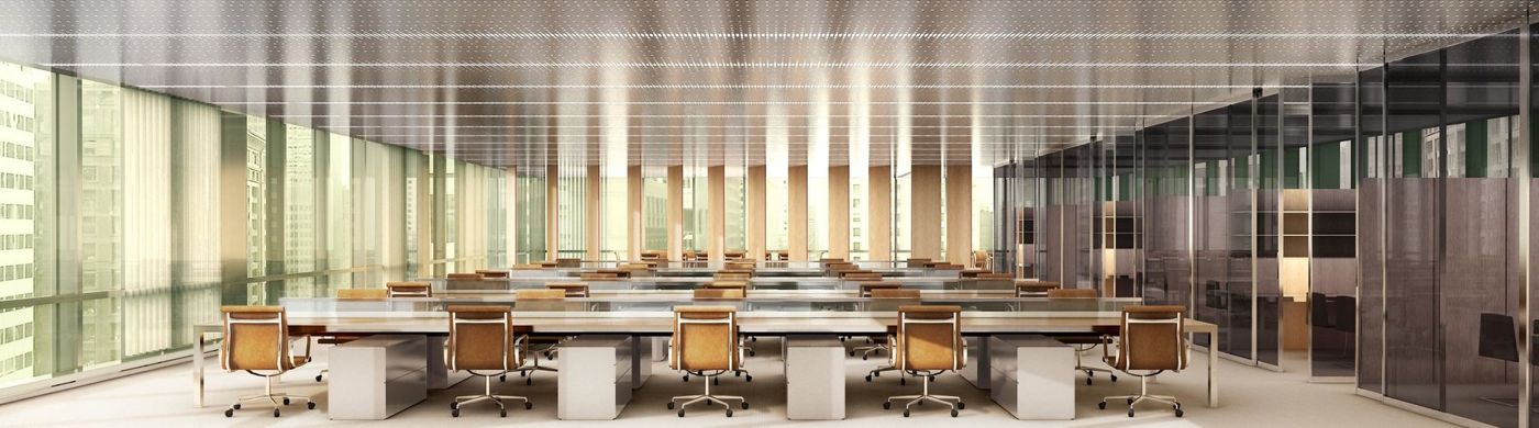 A long open office floor with rows of white desks and pale chairs along the glass wall.