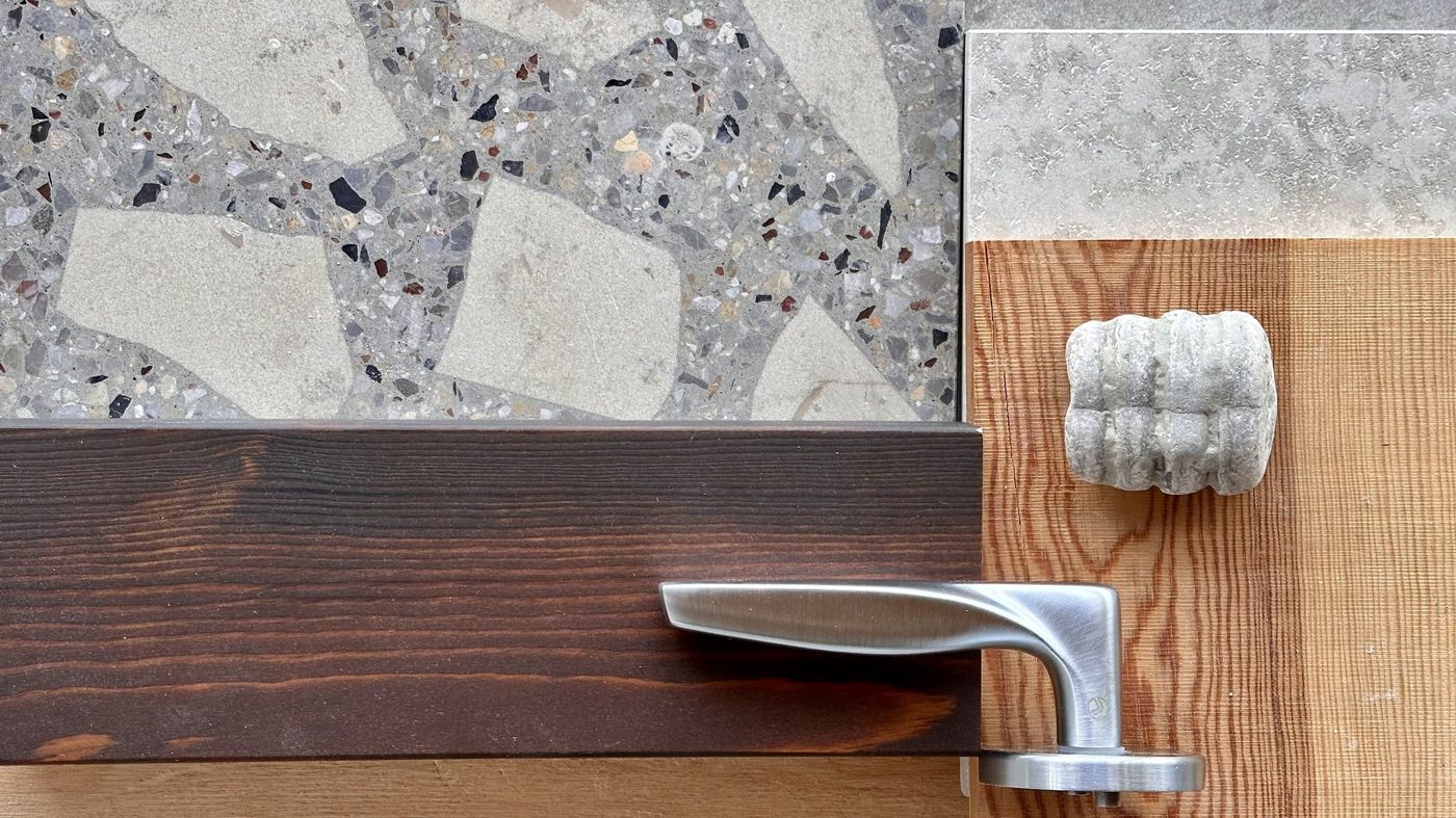 Terrazzo, resin-finished pine, limestone and a door lever, laid out together as they will be joined.