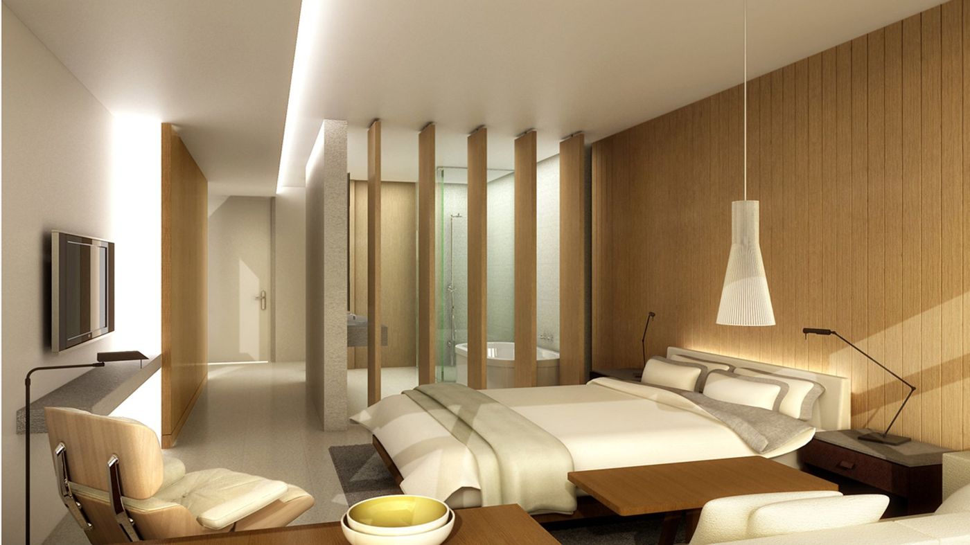 A guest room with a low bed, timber wall panels, louvred screen and a pendant lamp.