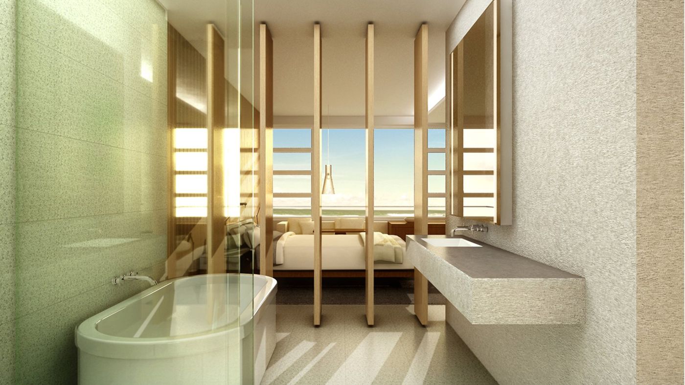 A freestanding bath and stone basin with timber louvres opening to the bedroom and window.