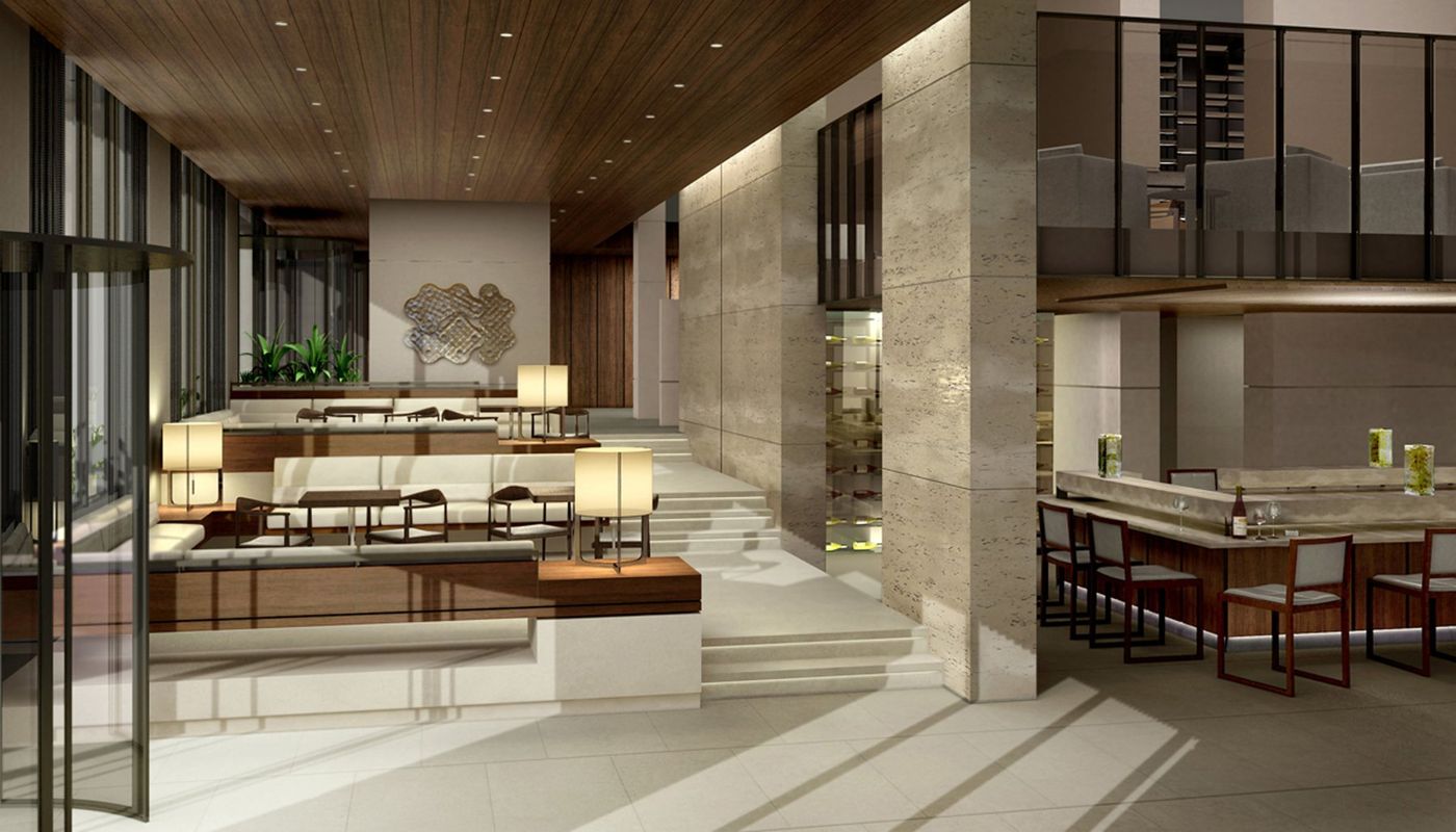 A two-level lounge with timber ceiling, stone walls, low seating and a bar to the right.