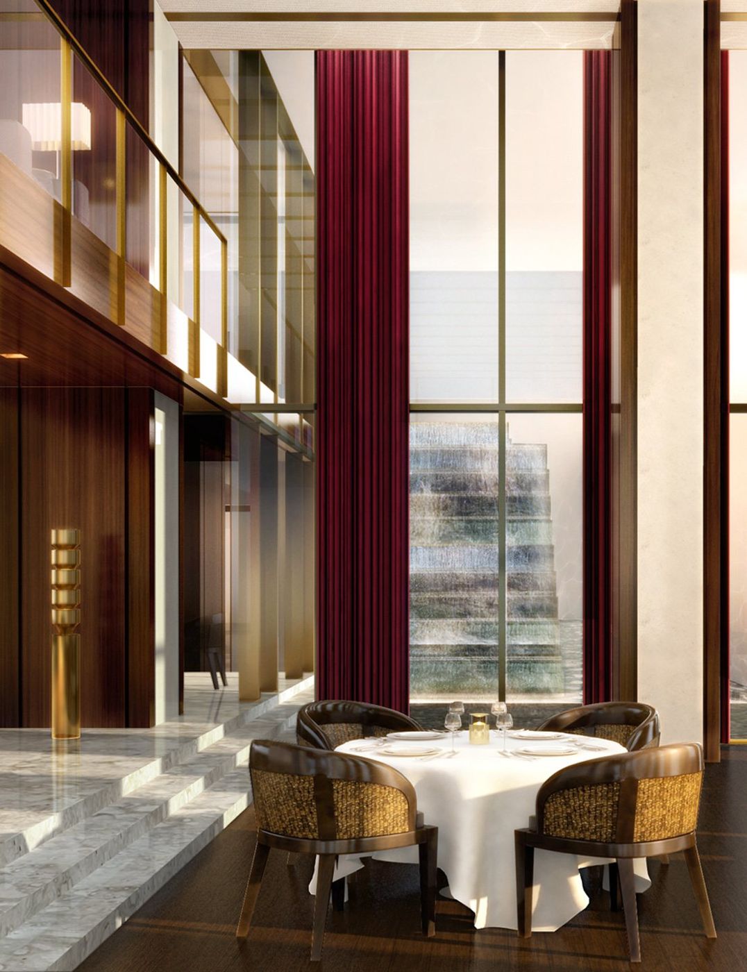 A round dining table under a double-height window hung with deep red curtains.